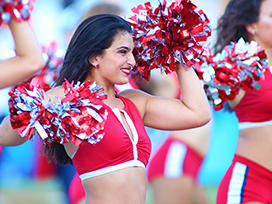 Female cheerleaders on the field during a game.